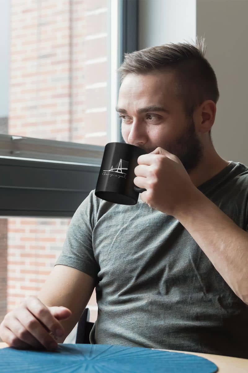 11 oz Motivational Mug with a man drinking water and looking out the window