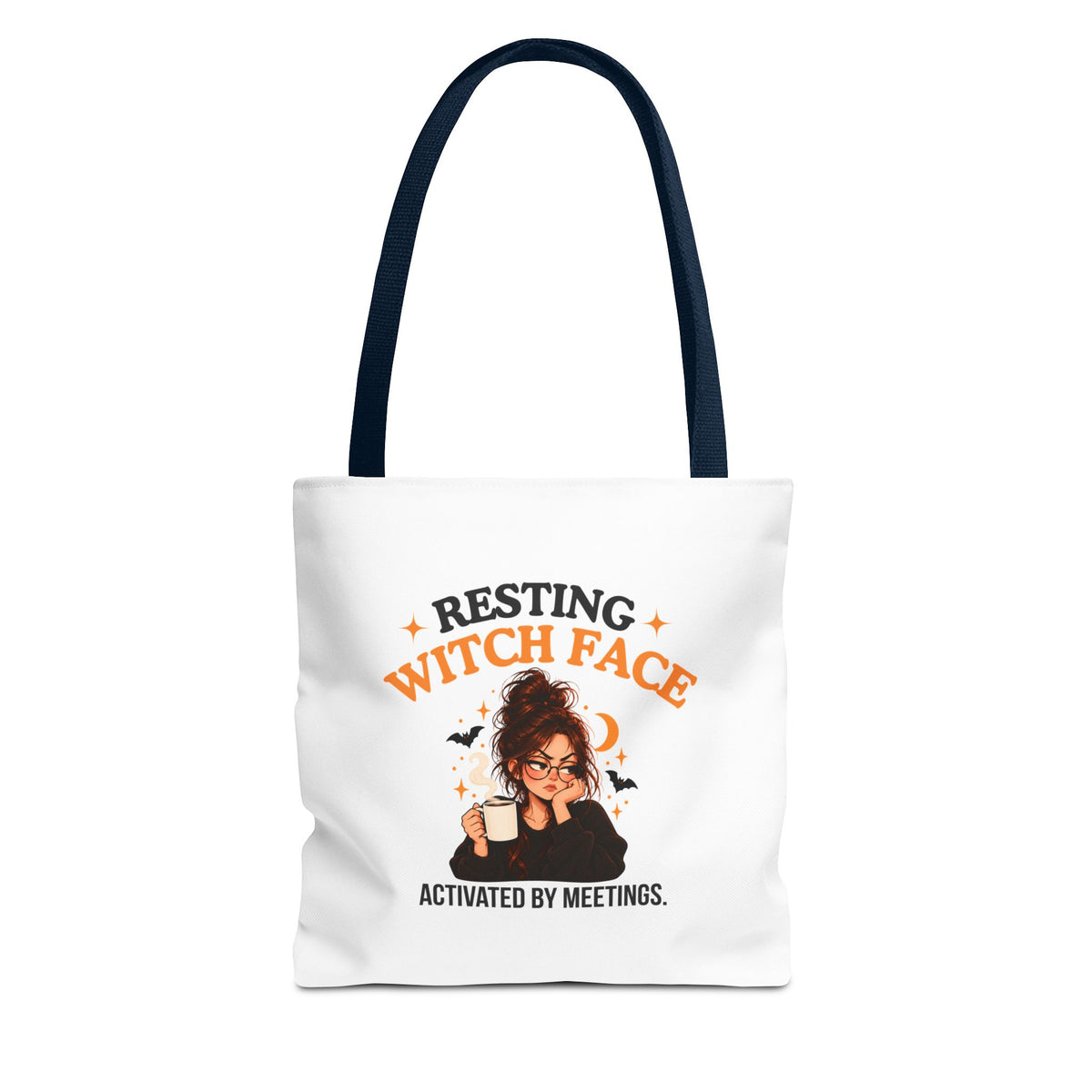 A white canvas tote bag with navy shoulder straps, featuring a cartoon witch graphic and the text 'Resting Witch Face. Activated by Meetings.' on a plain white background.