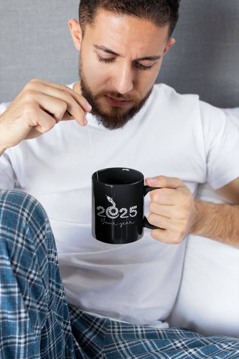 2025 Your Year Mug with a guy holding a glass of water and looking into his cup of tea