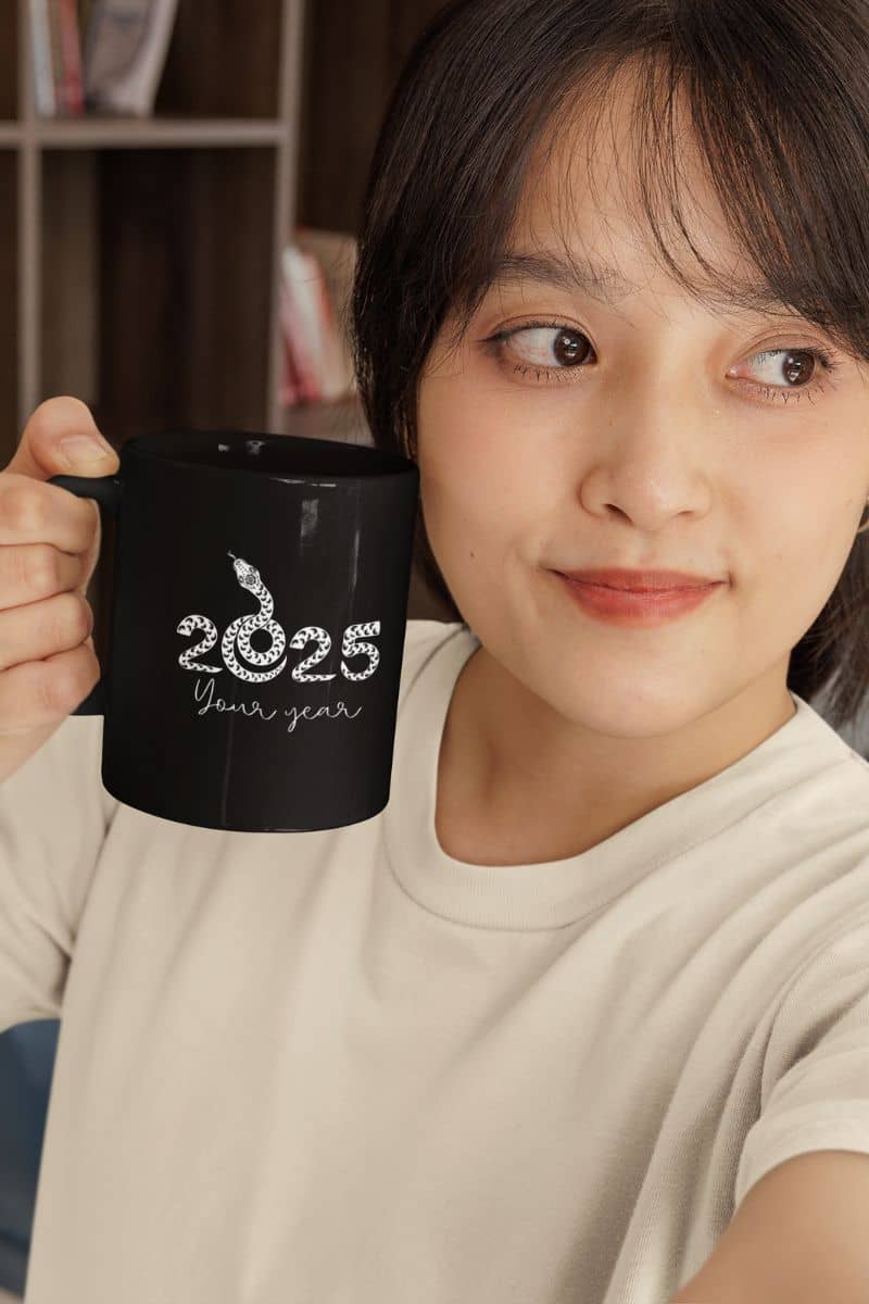 2025 Your Year Mug with a young girl holding a cup while working