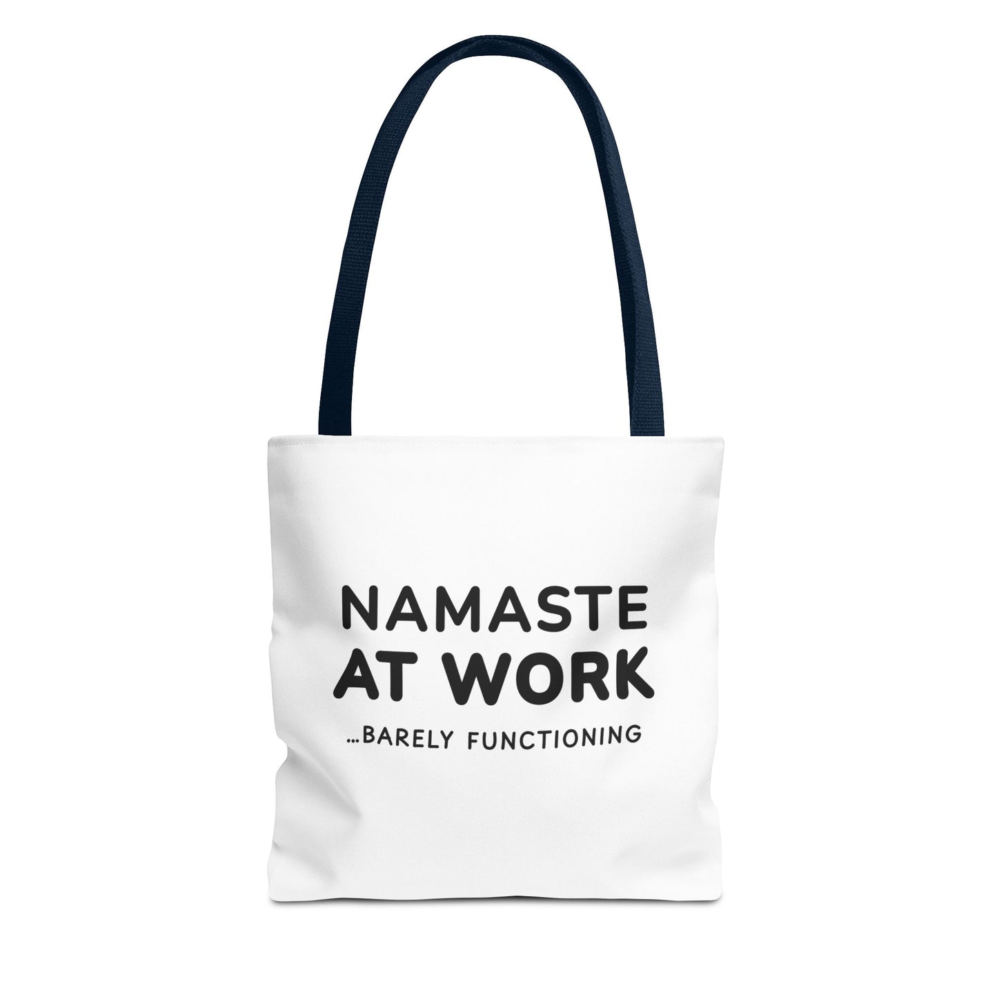 White tote bag with navy handles and text 'Namaste at Work...Barely Functioning' on a white background