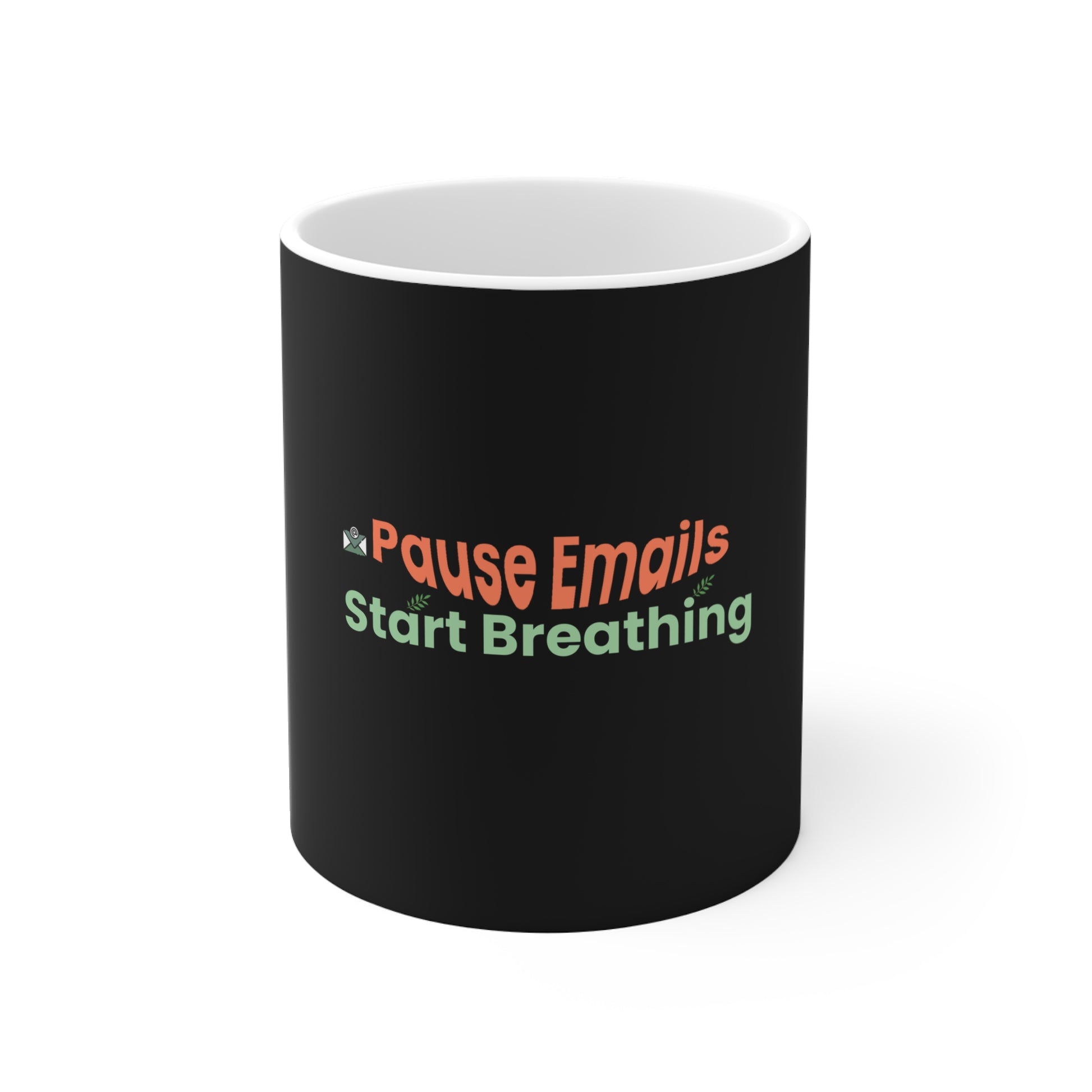 Black mug with colorful text 'Pause Emails Start Breathing' on a white background
