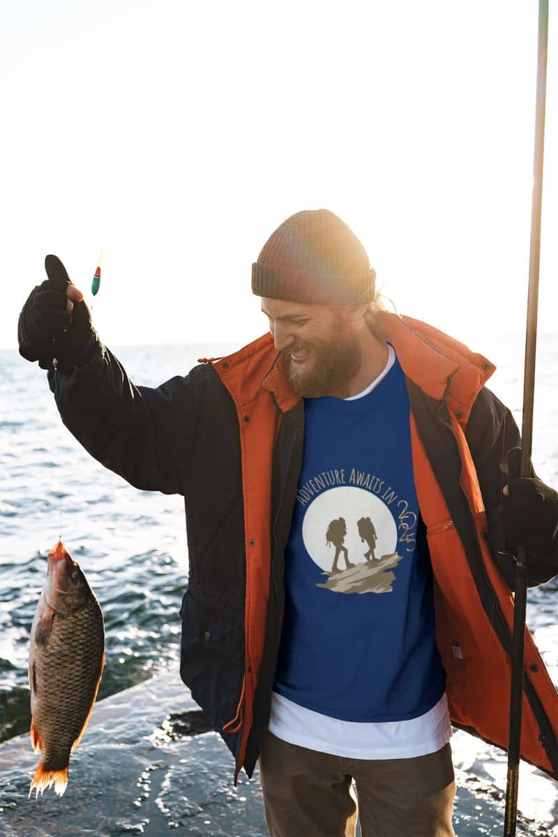 Adventure awaits in 2025 sweatshirt to a man who was smiling when he caught a fish on the river bank