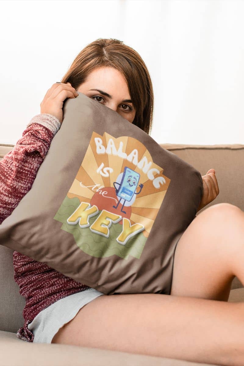 Balance is the key pillow Balance is the key pillow with the girl sitting on the sofa hugging a pillow covering half her face