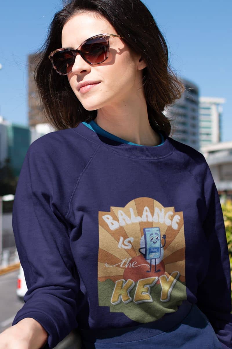 Balance is the key sweatshirt with a girl wearing glasses posing on the balcony