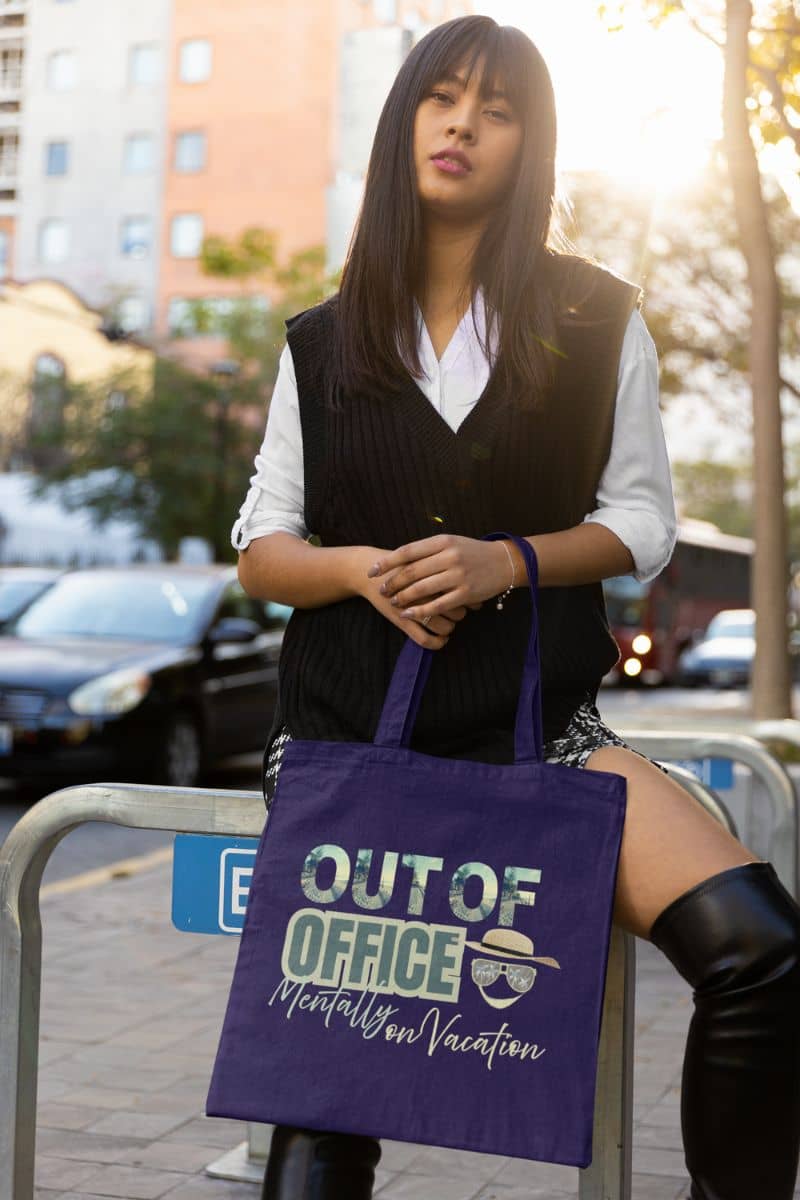 Beach tote bag with the girl sitting on the road barrier