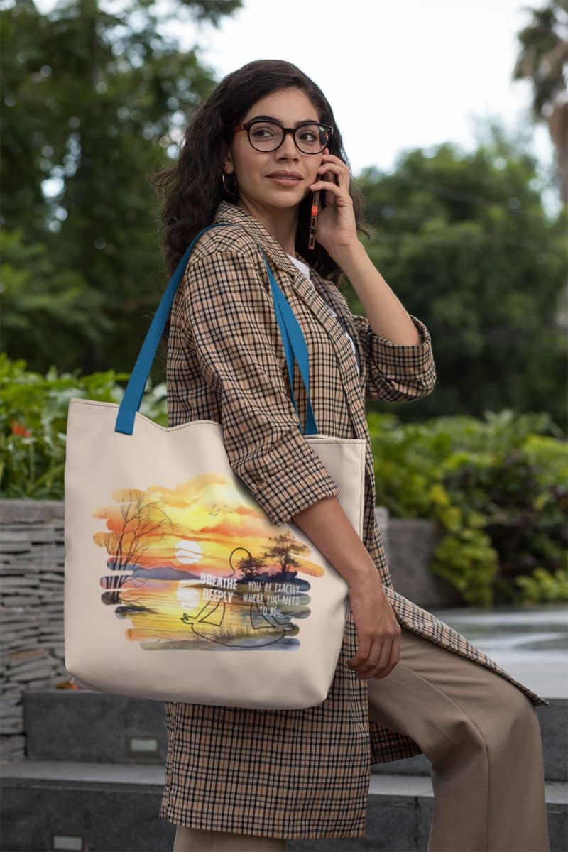 Breathe Deeply Tote Bag with a woman on the phone as she walked up the stairs