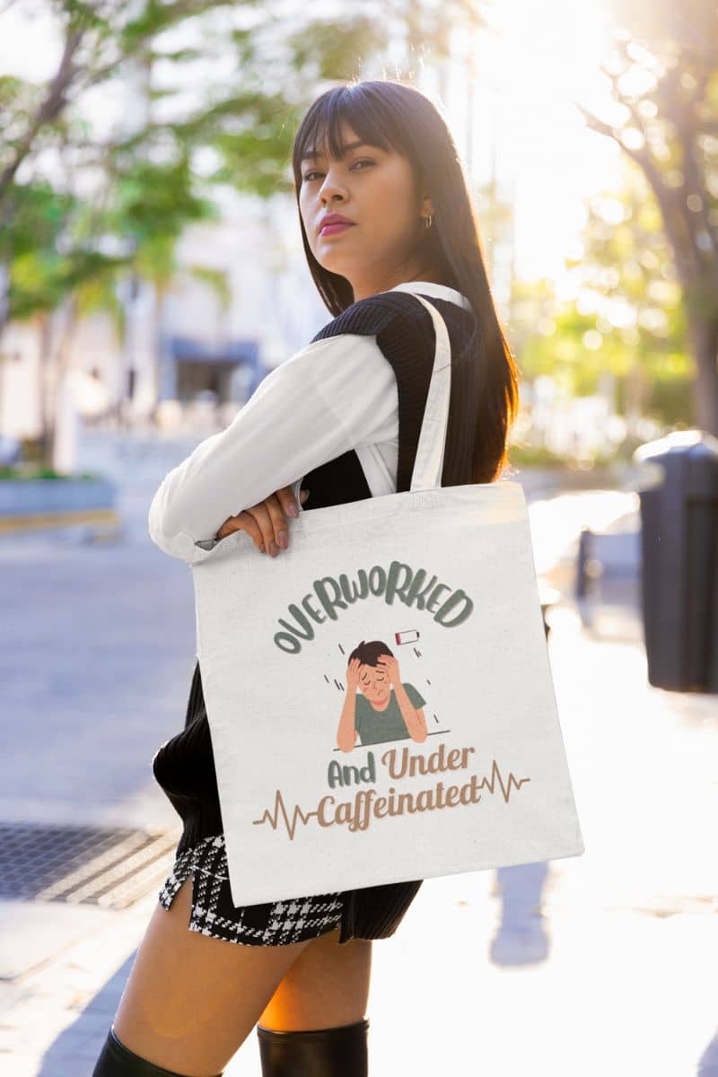 Caffeine addict tote bag with a girl wearing a tote bag and posing on the side of the road