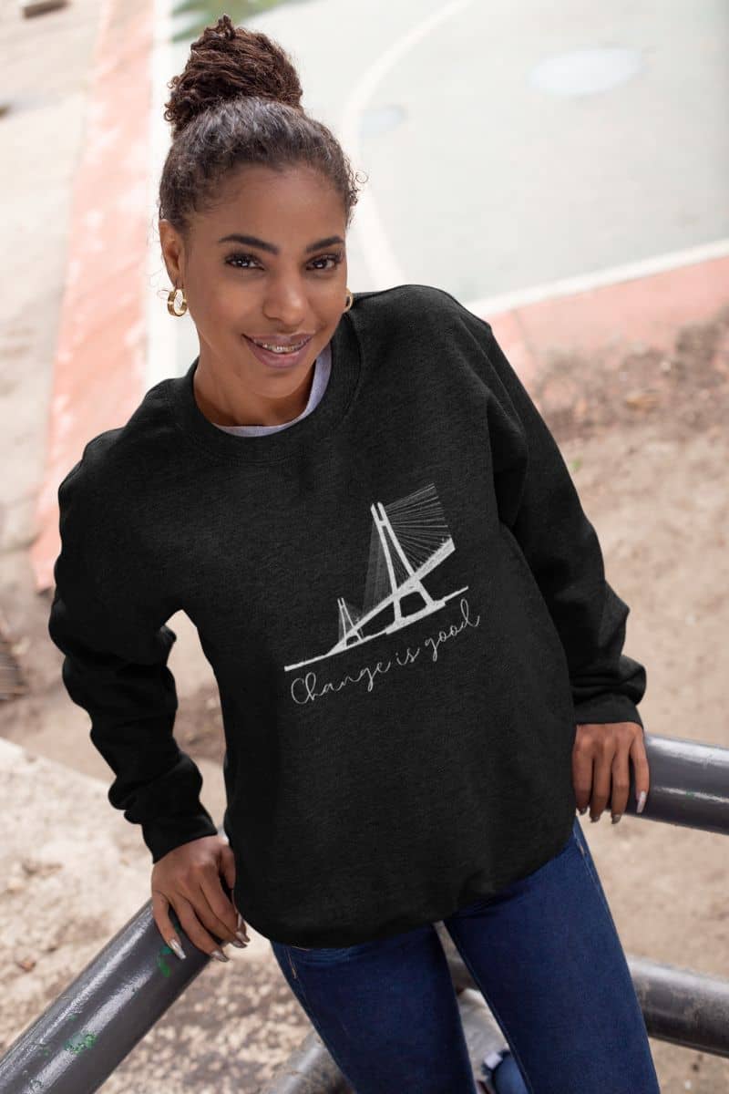 Change is good sweatshirt with the girl standing and posing on the balcony