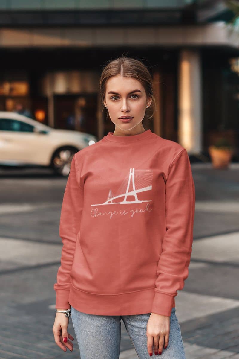 Change is good sweatshirt with the girl standing and posing in front of the building