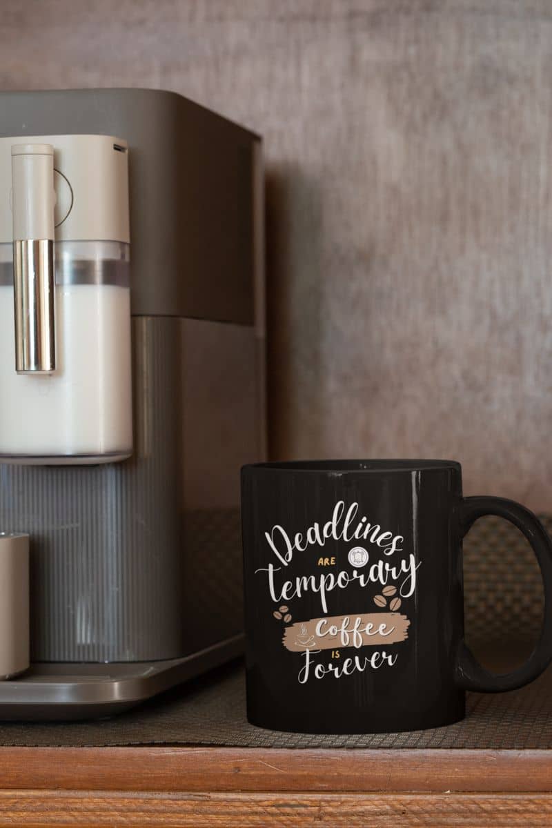 Charming coffee addict mug with a cup of coffee next to a coffee maker