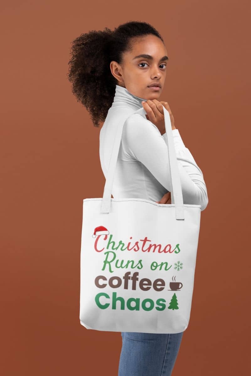 Christmas shopping tote with a woman holding a tote bag with 'Christmas Runs on Coffee Chaos' text against a brown background