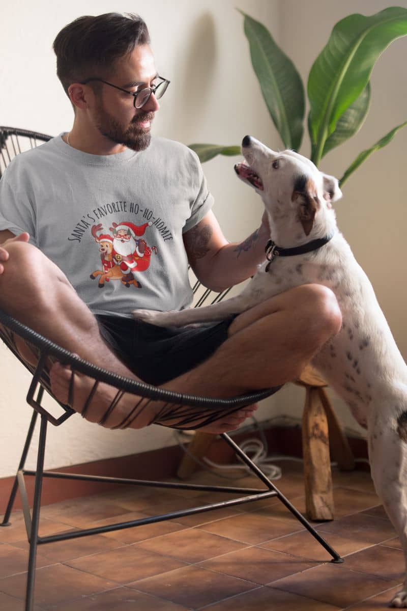 Christmas unisex T-shirt with a man talking to his dog on his chair