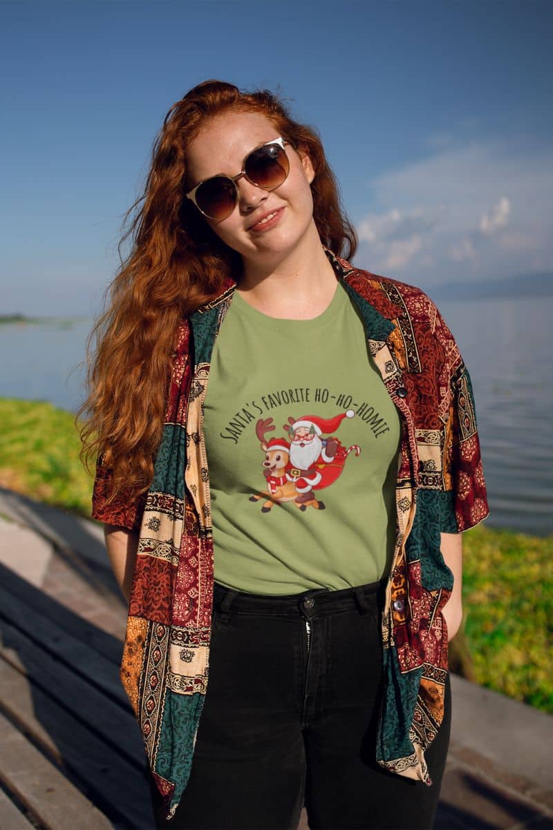 Christmas unisex T-shirt with a girl posing on the beach while traveling