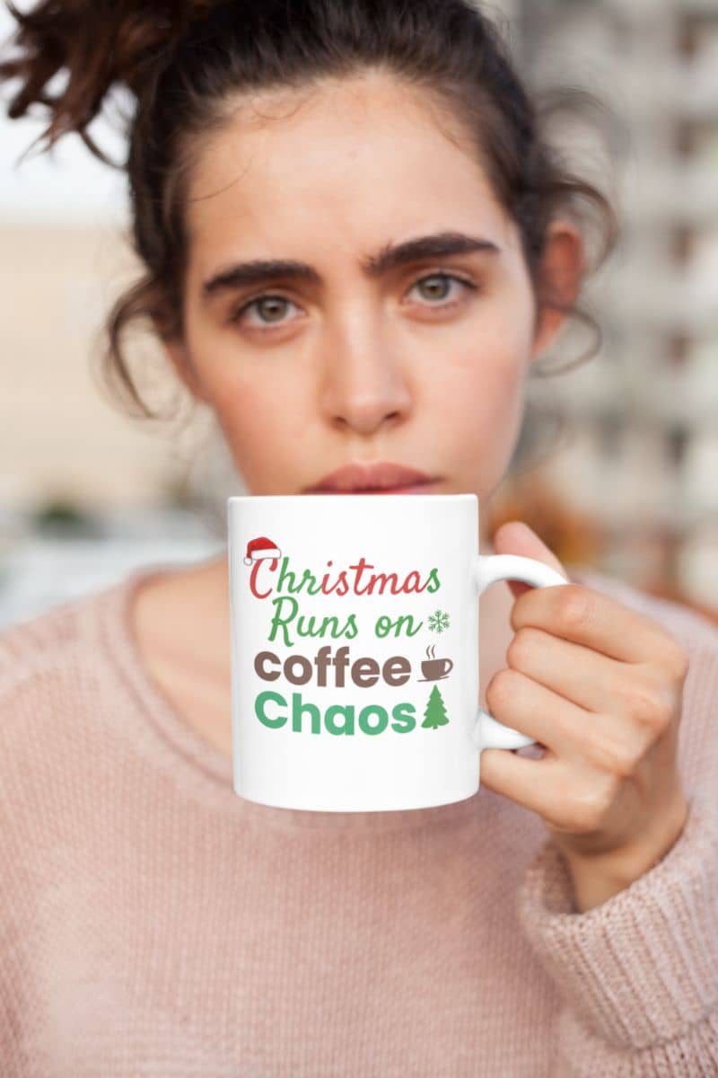 Coffee lover holiday mug with a woman holding a mug with 'Christmas Runs on Coffee Chaos' text
