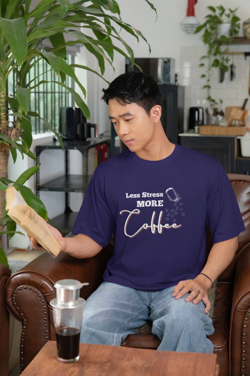 Coffee lover t-shirt with a guy reading a book on the sofa