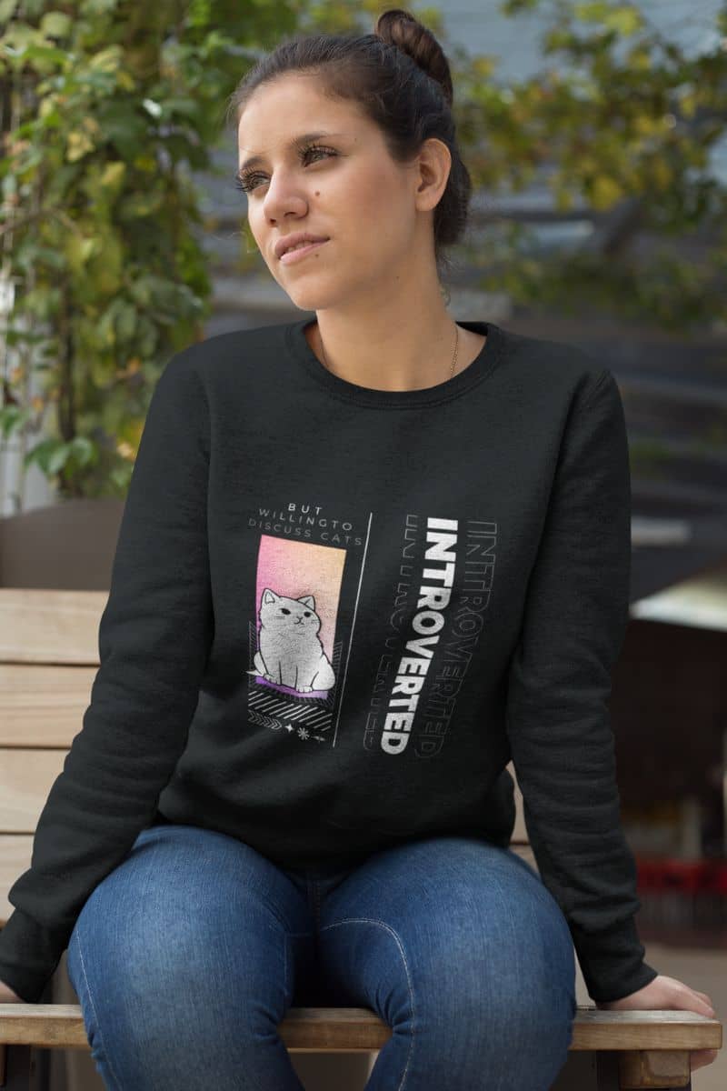 Comfy introverted sweatshirt with a girl sitting pensively on a wooden bench in the courtyard of the house