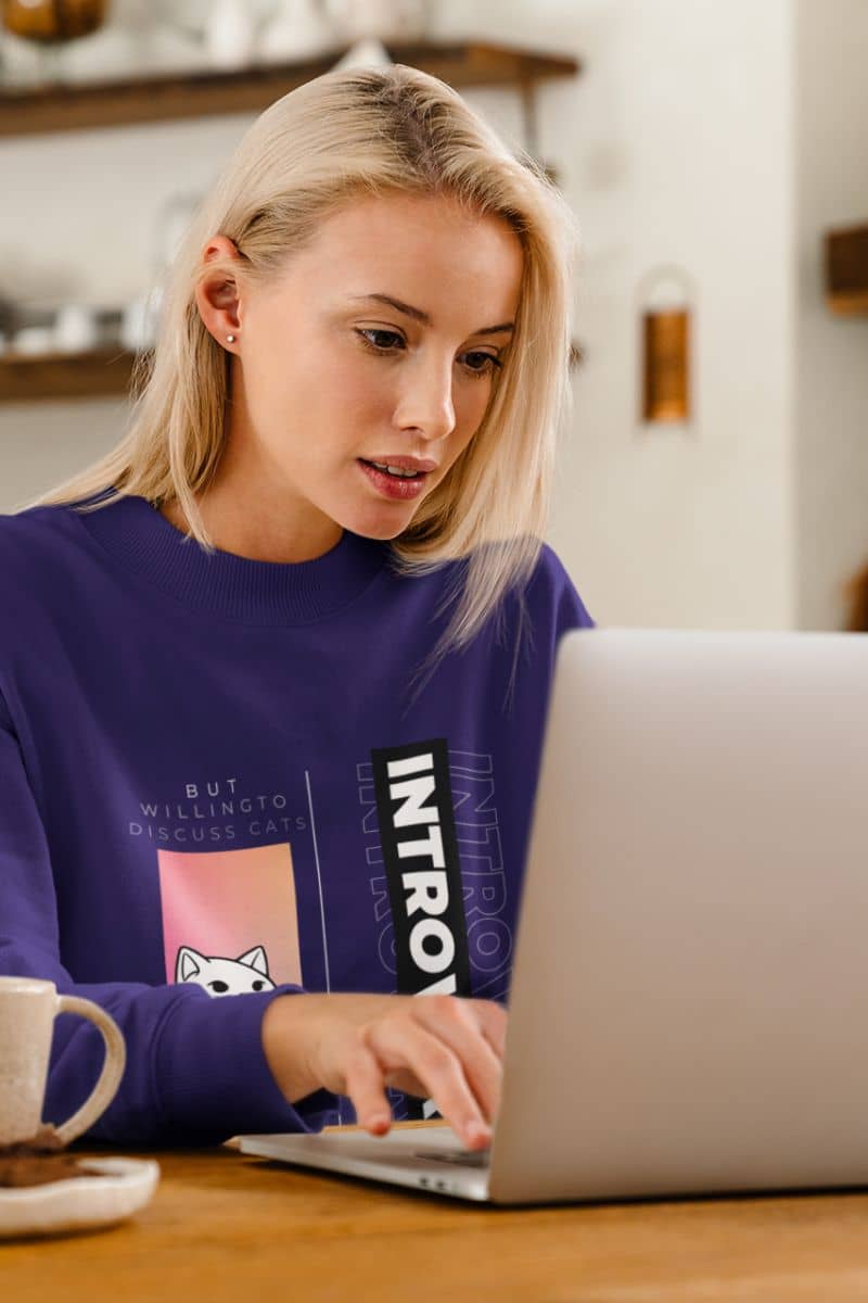 Comfy introverted sweatshirt with a blonde girl sitting working on a laptop