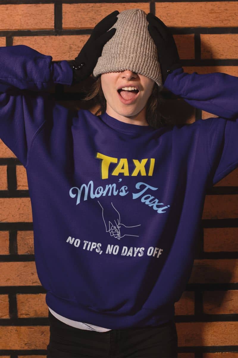 Comfy mom's taxi sweatshirt with a girl posing with a woolen hat covering her eyes