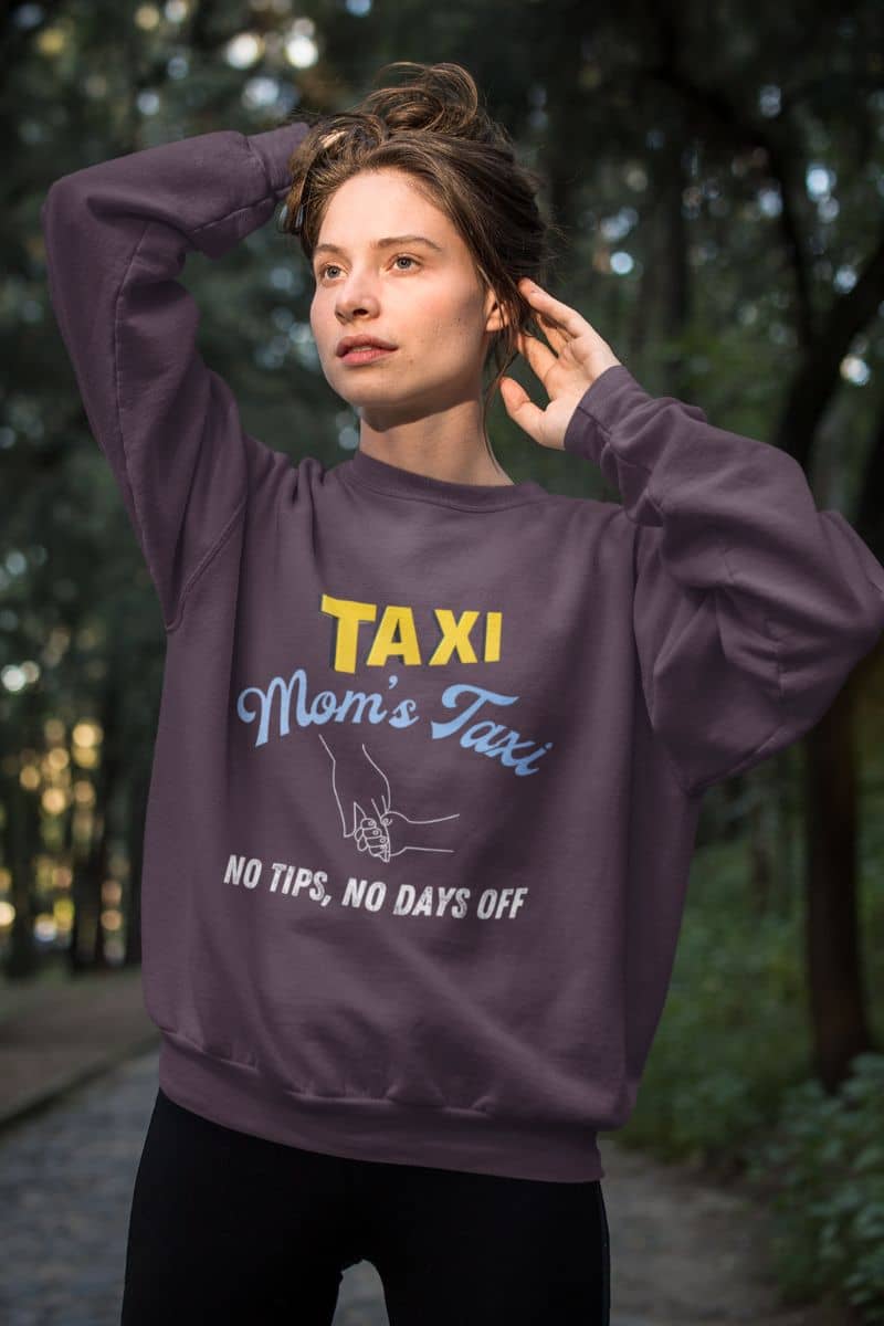 Comfy mom's taxi sweatshirt with a girl pulling her hair up to pose in the woods