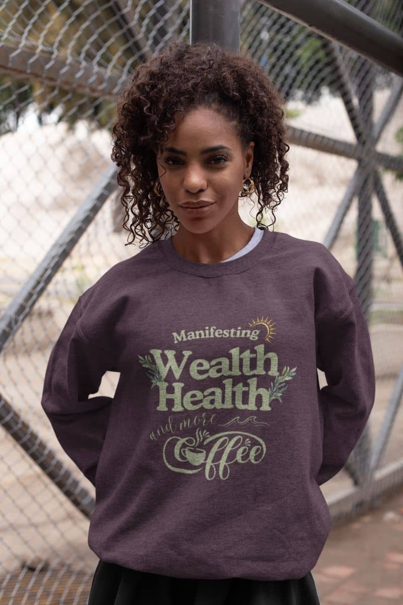 Cozy manifestation sweatshirt with a girl leaning against an iron pillar posing