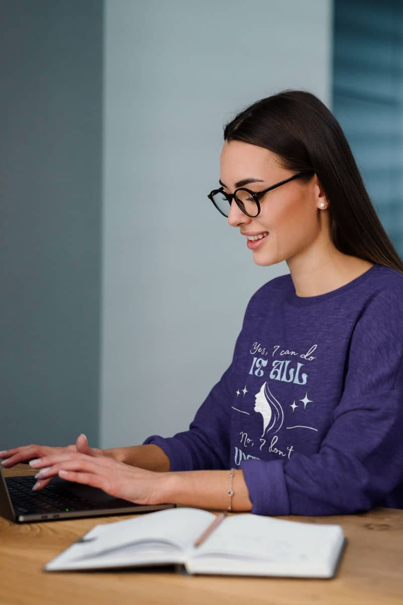 Cozy sarcastic sweatshirt with a girl sitting working on a laptop