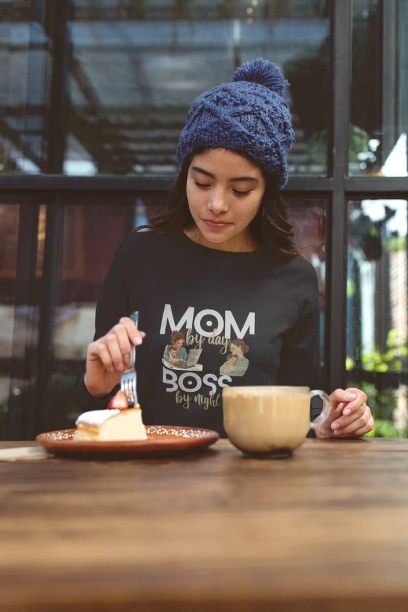 Cozy sweatshirt for moms with a girl sitting eating cake and drinking coffee in a cafe
