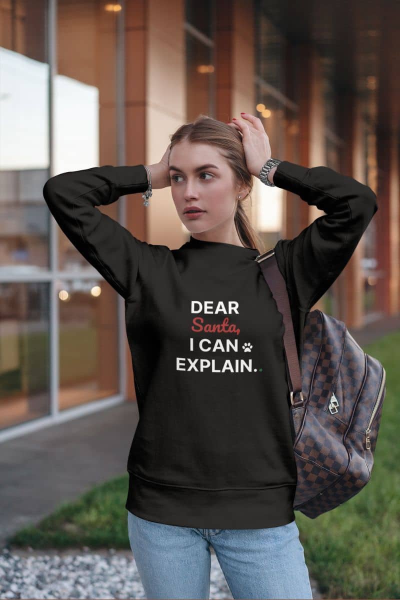 Dear Santa I can explain sweatshirt with a girl wearing a black sweatshirt with text outdoors