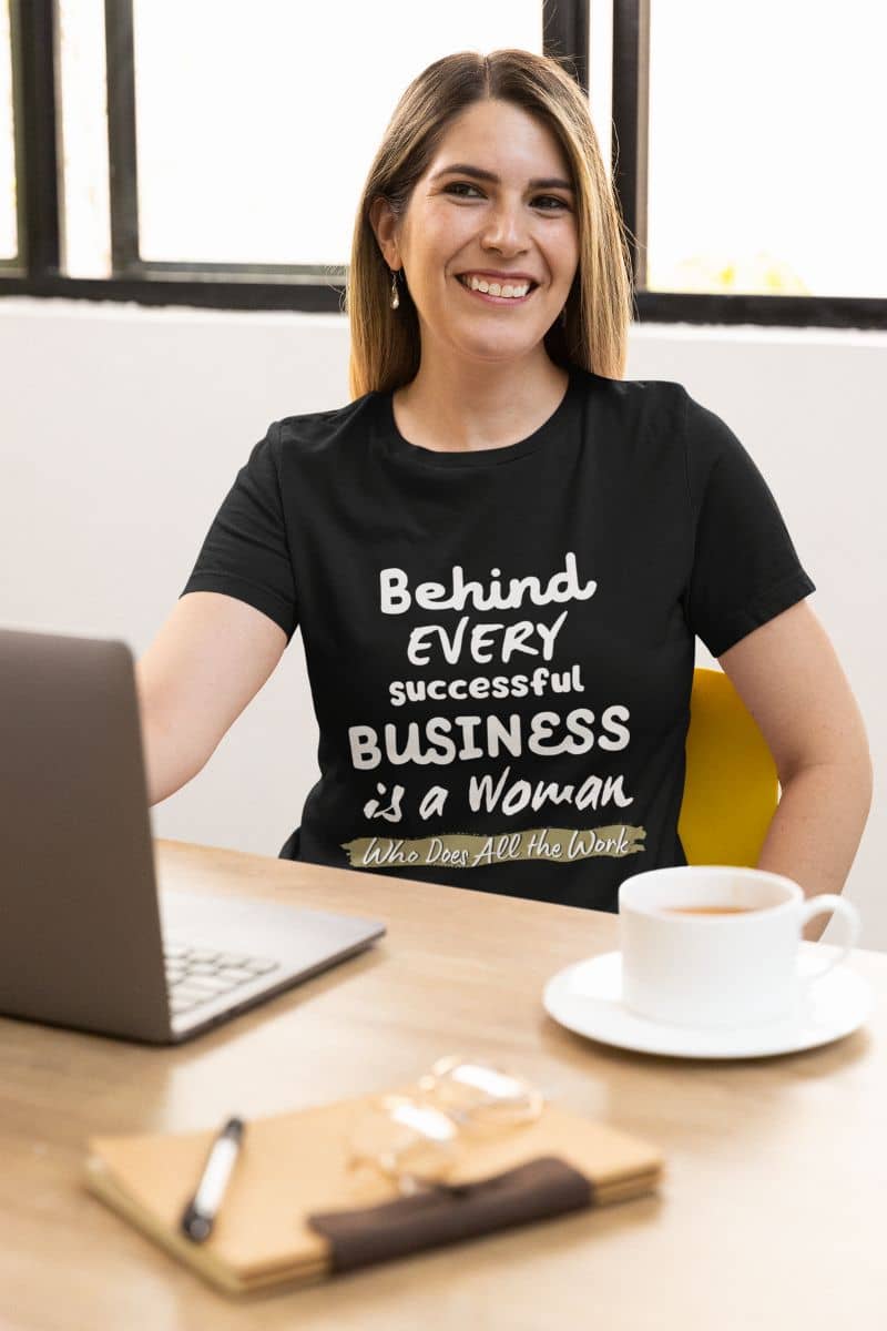 Empowering-tshirts with a woman smiling while working
