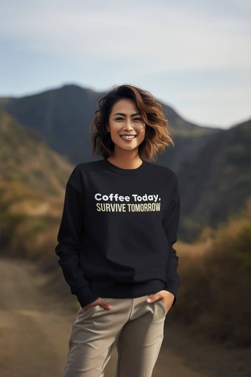 Espresso quote sweatshirt featuring a girl in a black sweatshirt with the text 'Coffee Today, Survive Tomorrow', standing on the road.