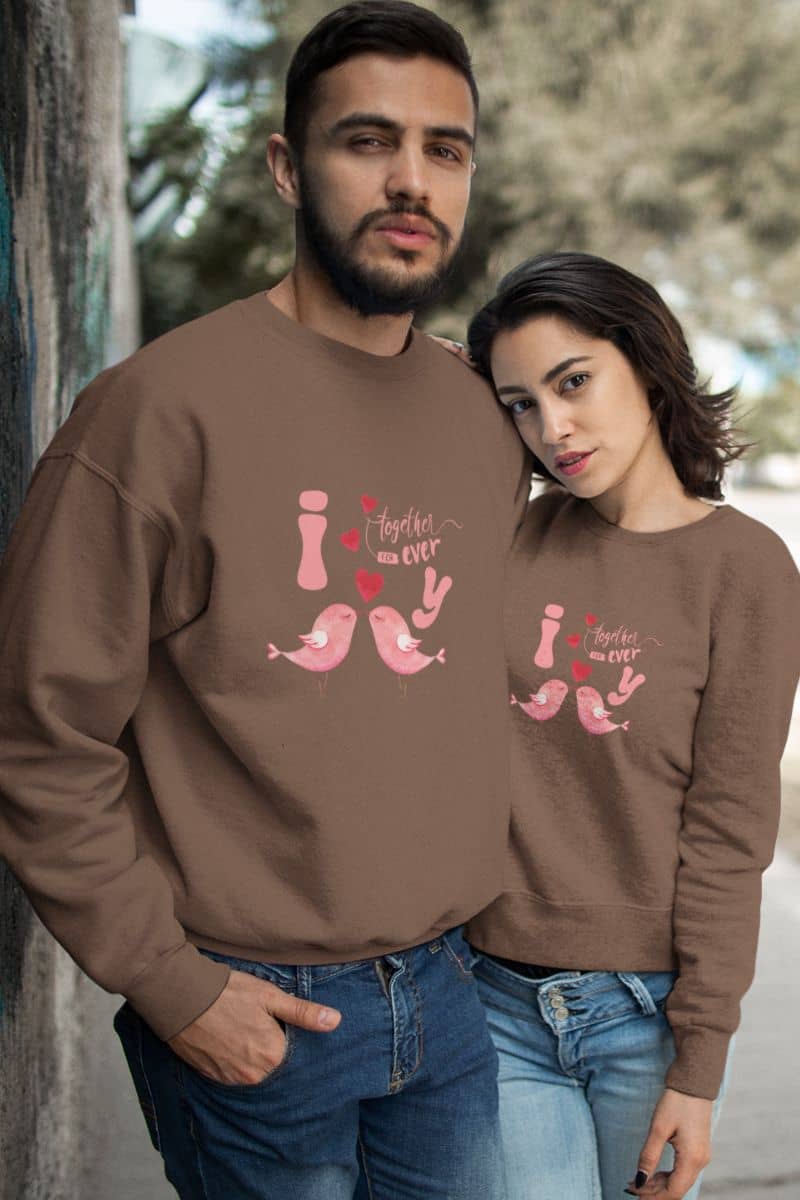 Eternal love birds sweatshirt with a couple posing on the side of the road and his girlfriend leaning on his shoulder
