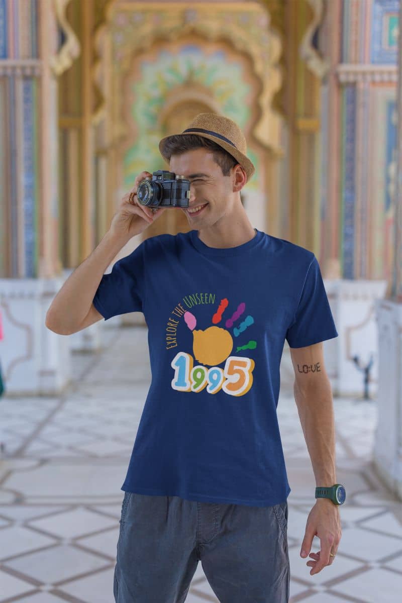 Explore the unseen t-shirt with a guy holding a camera at a tourist destination