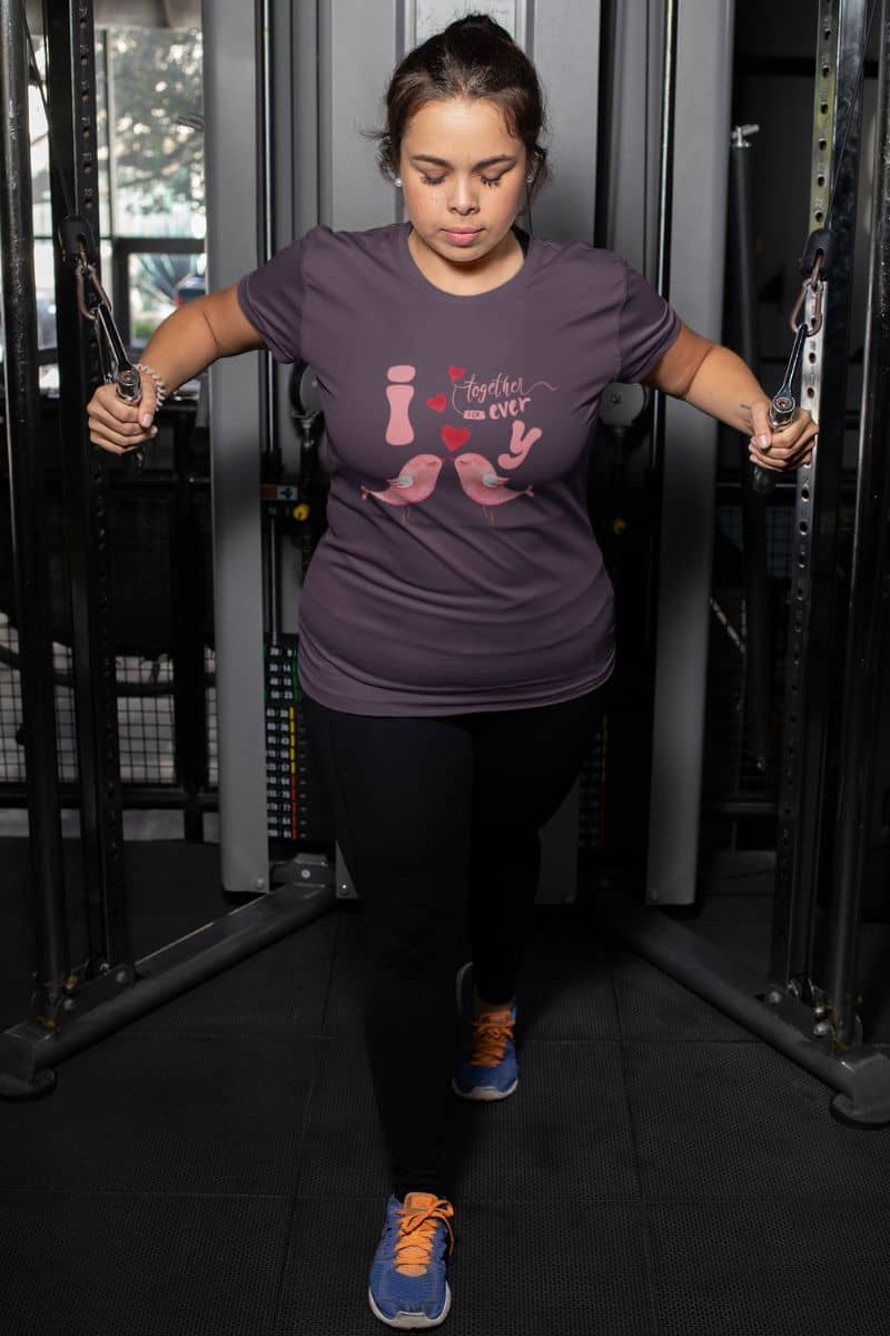 Forever love birds t-shirt with a girl doing arm exercises in the gym