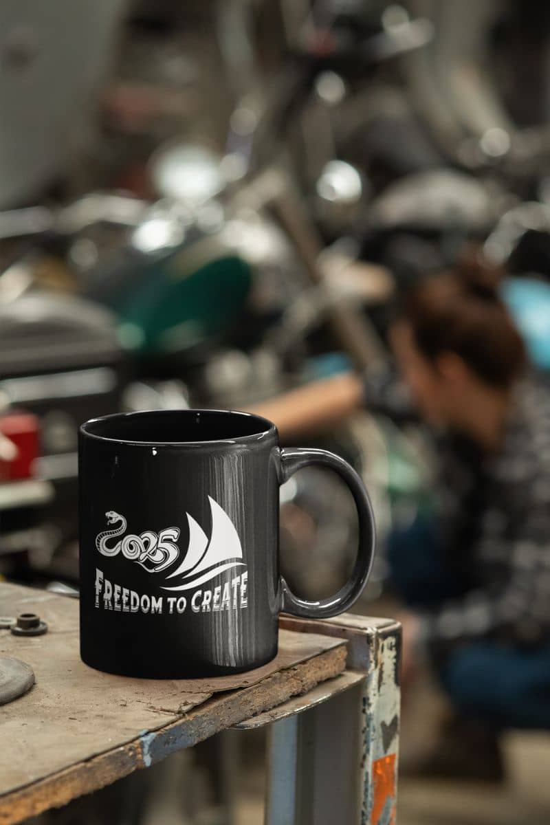 Freedom to create 11oz Mug with a girl repairing her car in the garage while her coffee cup lay on the tool table