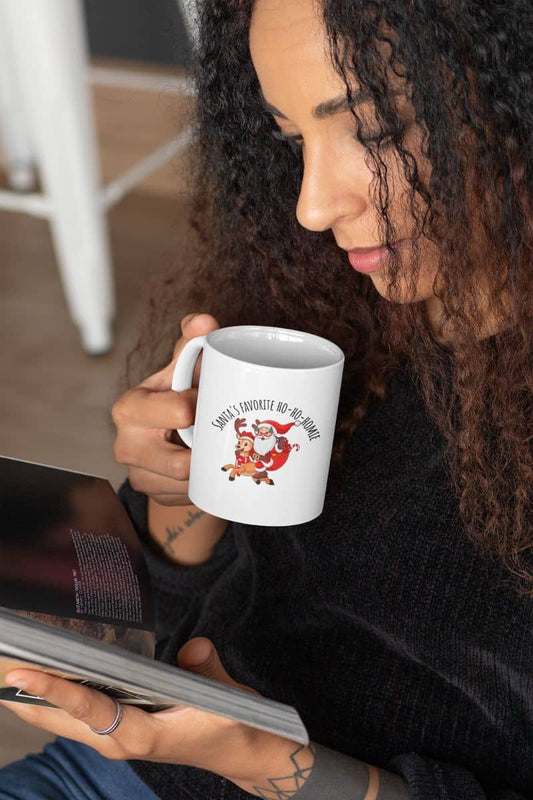 Fun Christmas mug with a girl reading a magazine and holding a glass of water
