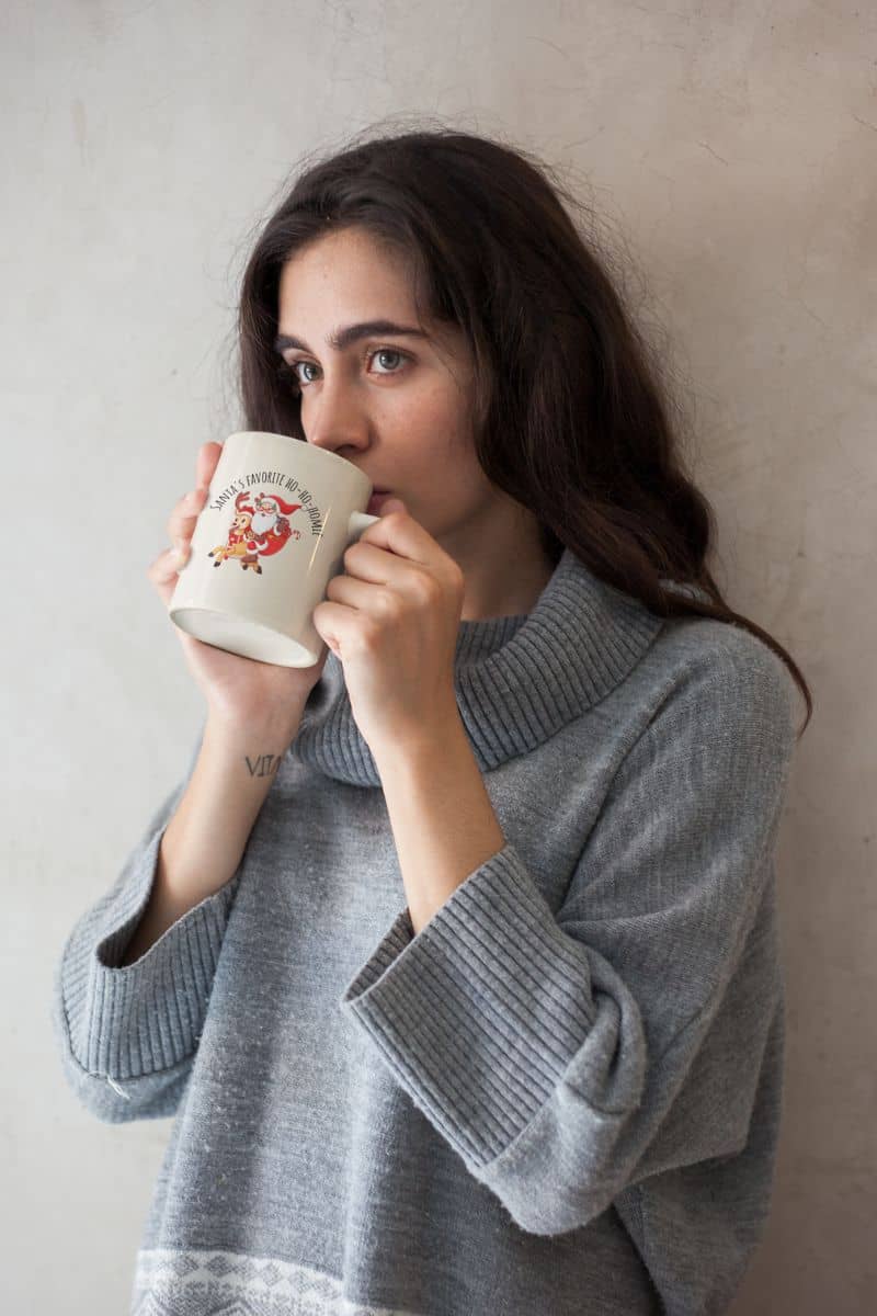 Fun Christmas mug with a girl holding a cup of hot water in the freezing winter