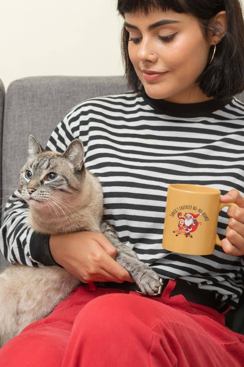 Fun Christmas mug with one girl holding a glass in her hand and the other holding her cat