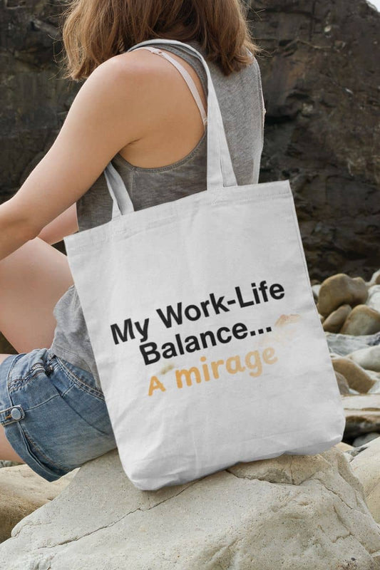 Funny work tote bag with a person sitting on rocks with a tote bag that says 'My Work-Life Balance... A Mirage'.