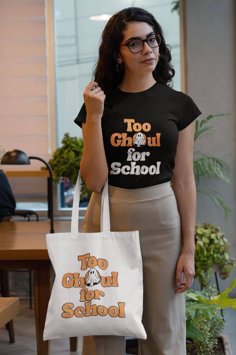 Ghost tote bag with a person wearing a black t-shirt and holding a tote bag with 'Too Ghoul for School' text.