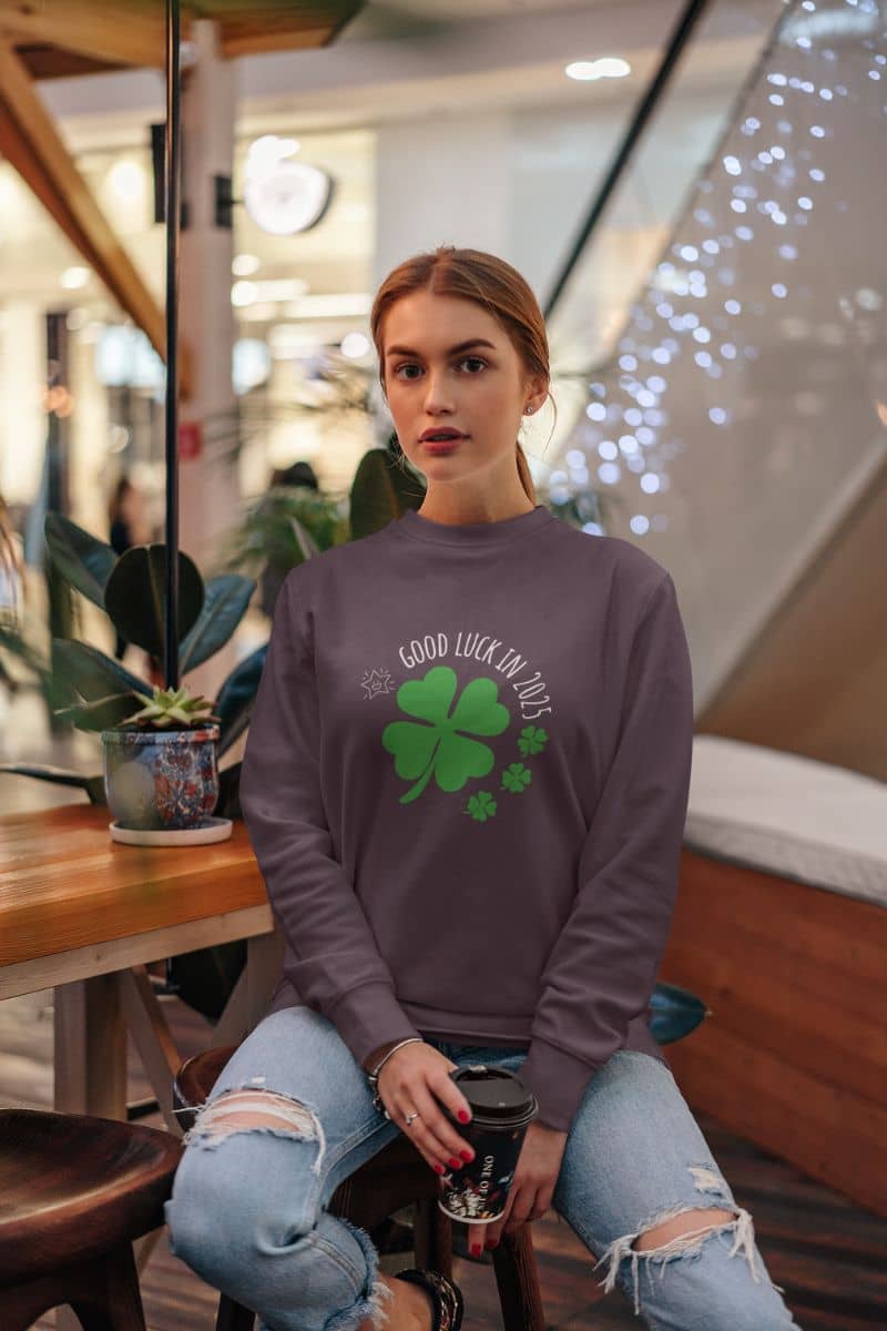 Good luck in 2025 sweatshirt with a girl holding a cup of coffee in a coffee shop