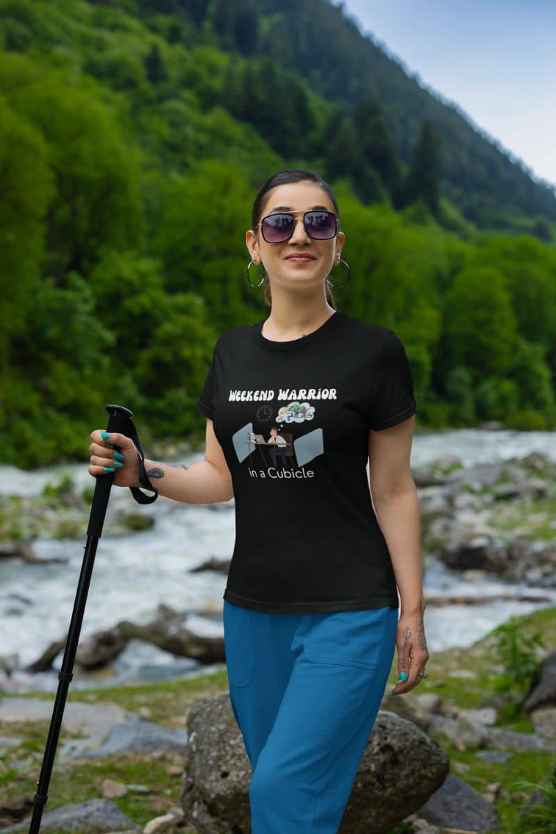 Graphic t-shirt for men with a girl wearing black glasses climbing the mountain with a stick