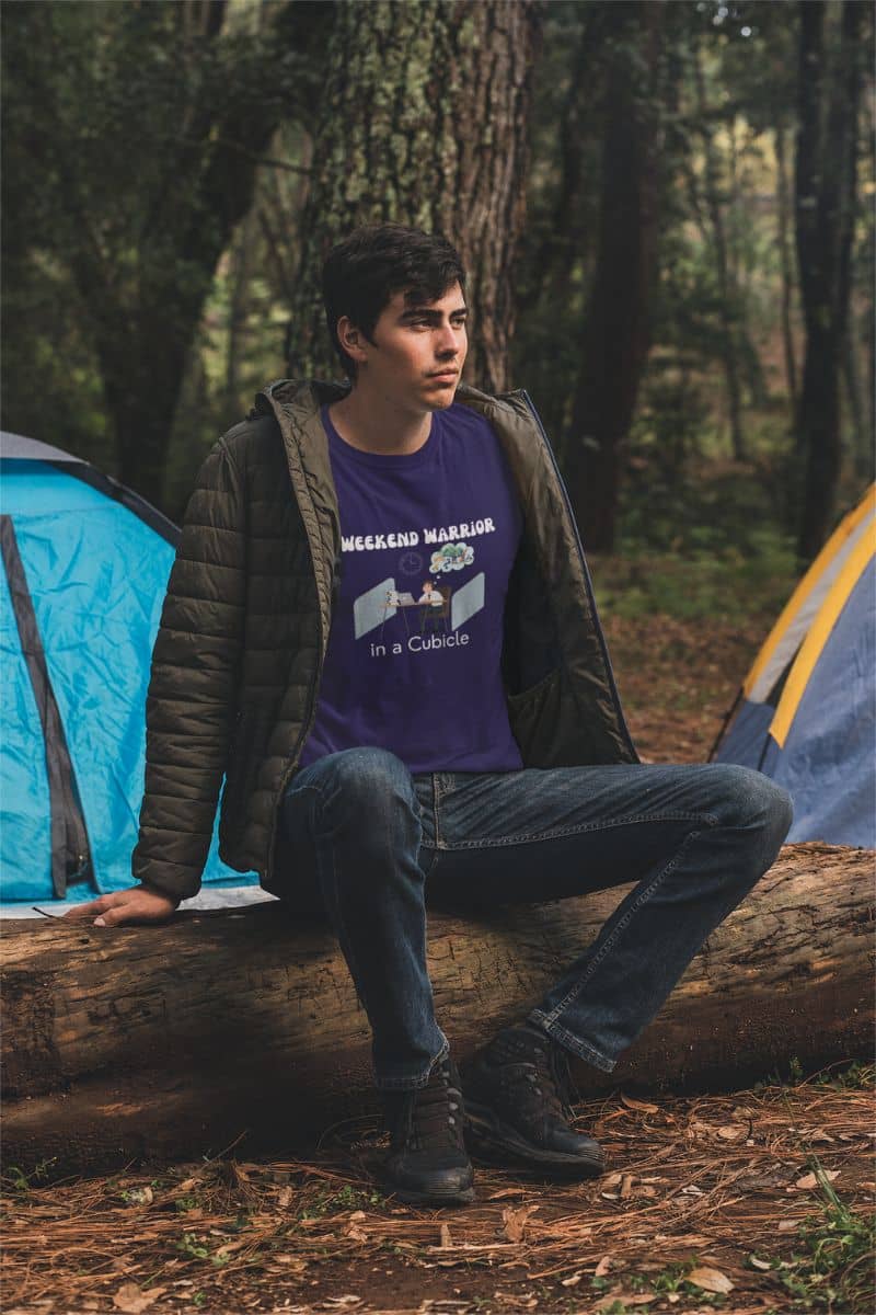 Graphic t-shirt for men with a guy sitting on a dry tree in front of the tents