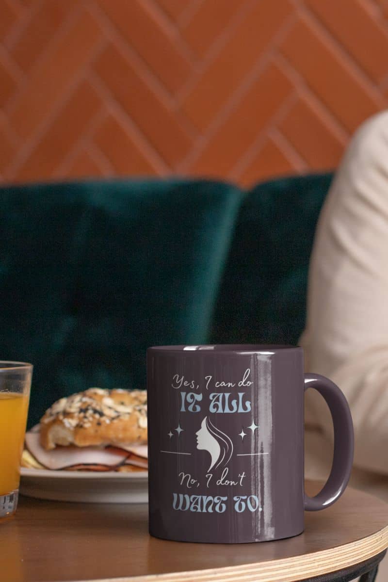 Hilarious coffee mug with a woman working on a computer next to a cup of coffee and a plate of bread