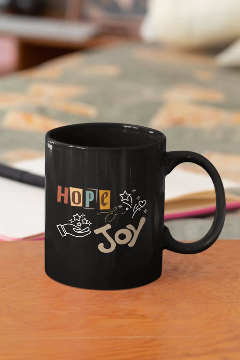 Hope and Joy Mug with a cup of coffee on the table