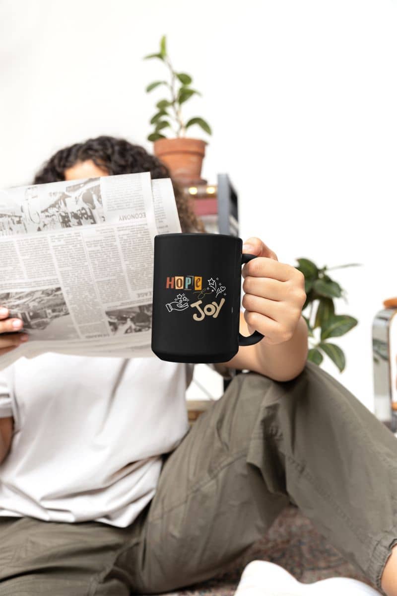 Hope and Joy Mug with a woman reading a newspaper on the sofa