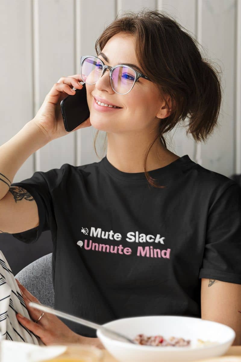 Humorous mental wellness shirt with a woman wearing a black t-shirt with text, sitting at a table with a bowl of food.