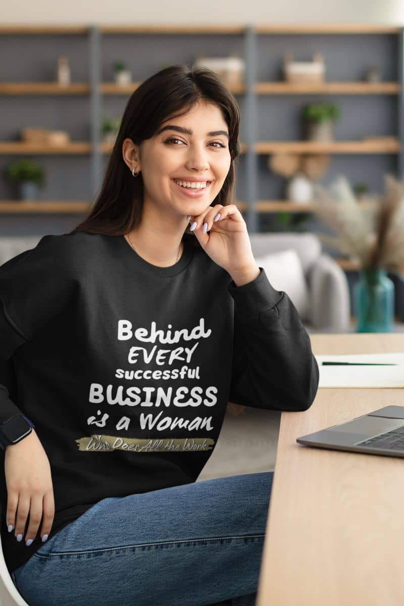 Inspirational sweatshirts with a woman smiling brightly while working at home