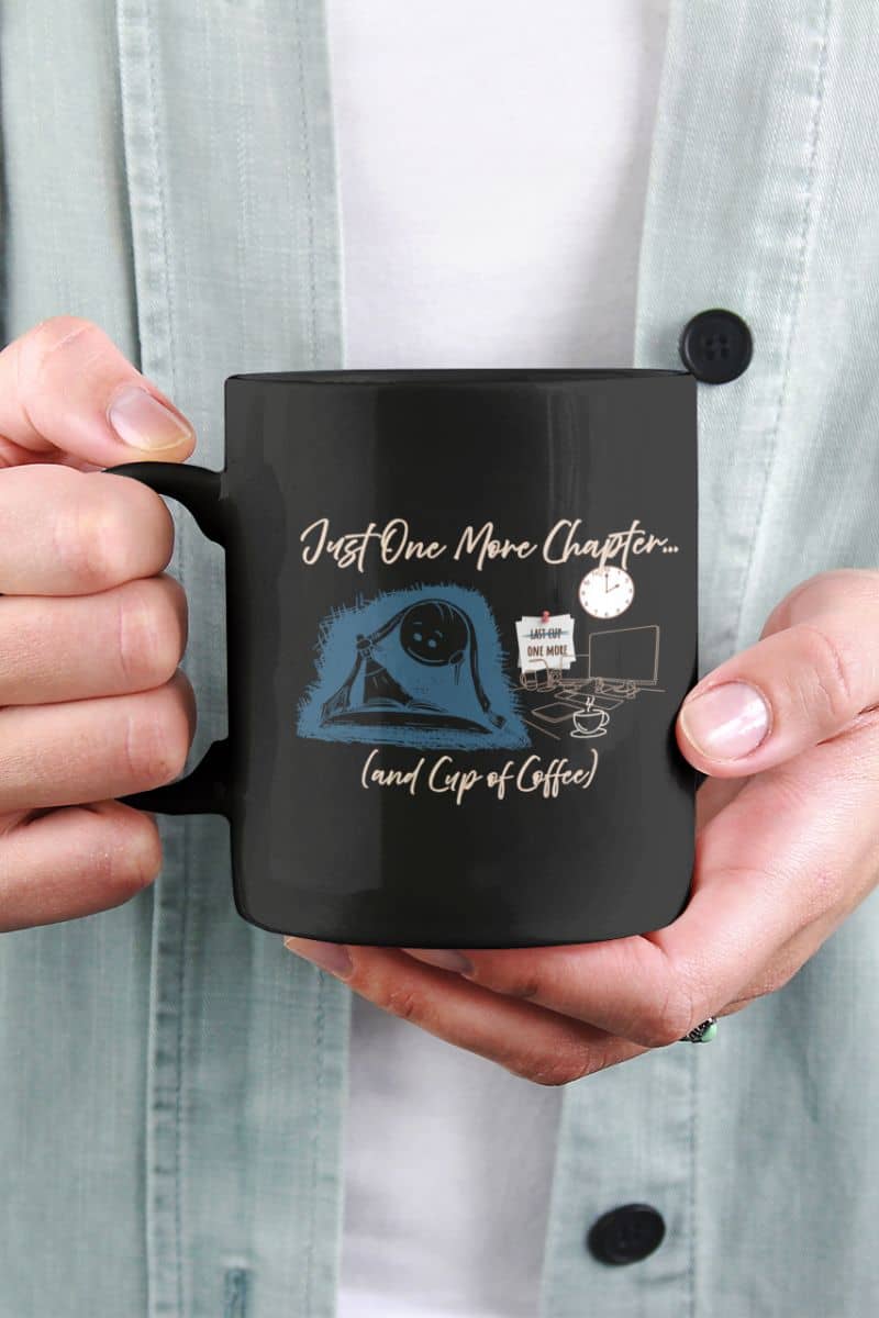 Just one more chapter coffee mug with a woman in a blue jacket holding a coffee cup in front of her chest