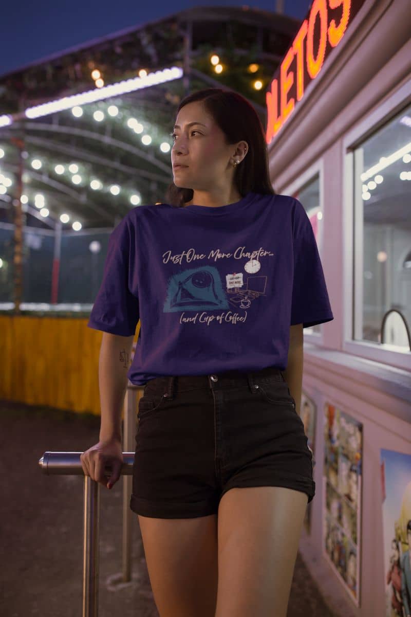 Just one more chapter t-shirt with a girl looking to one side as if waiting for someone before in front of a ticket office