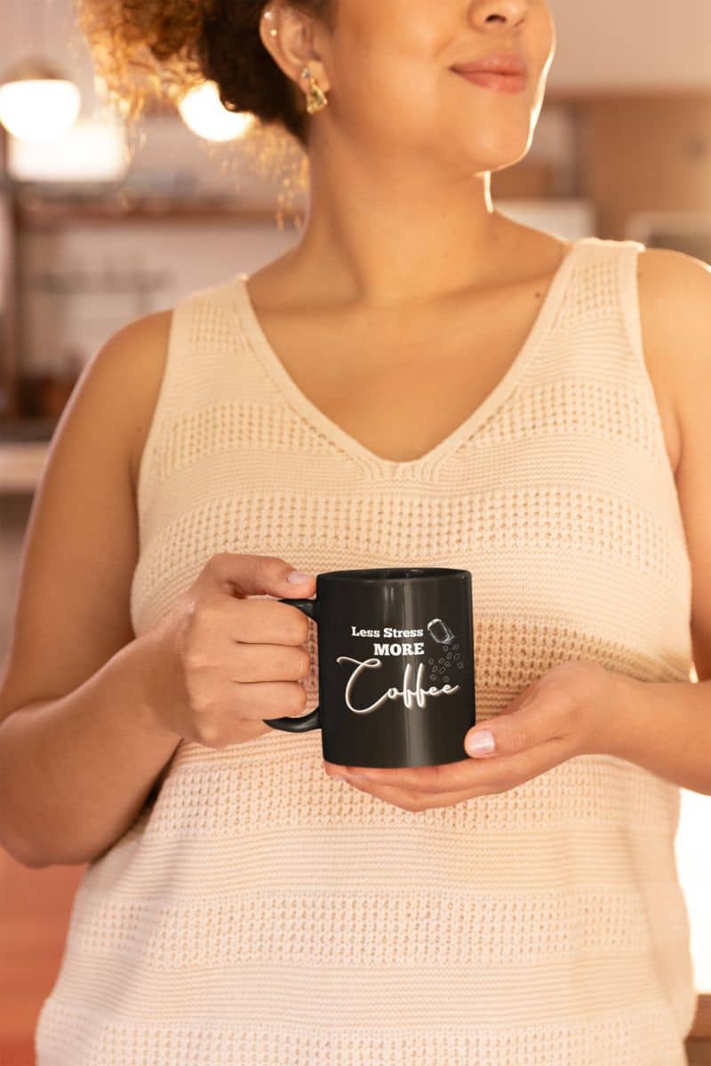 Less stress more coffee mug with a woman holding a cup to her chest